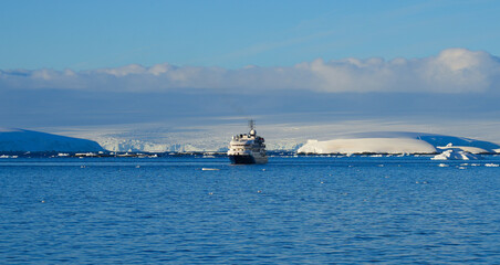 Cruise Ship entering Lemaire Channel off the coast of Antarctica, separating Kyiv Peninsula on the mainland and Booth Island