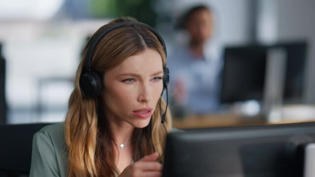 Technical support operator consulting client wearing headset at office closeup.