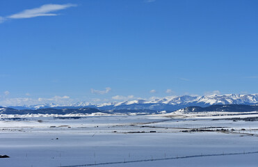 Snow covered mountains across the frozen plain