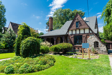 Suburban home in private residential housing. House exterior architecture. Housing in neighborhood. Housing estate. Private house architecture. Private housing property. Residential suburban house