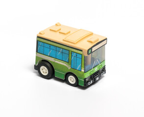 Small green toy bus on a white background