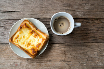 Hot coffee and toast on a wooden table