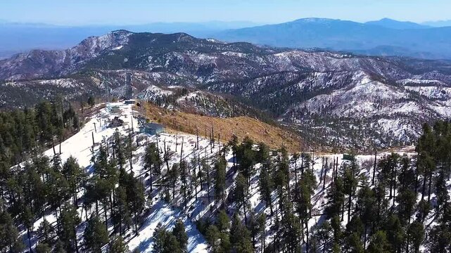 Overlooking Mt. Lemmon Arizona's cell phone tower, snowy pine trees, with the Rincon Mountains in Tucson