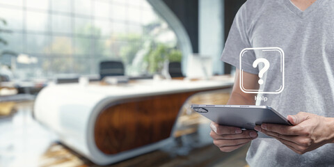 Person Holding Tablet with Help Icon in Modern Office Setting
