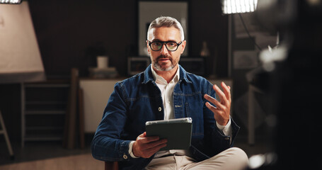 Mature man, discussion or online interview with tablet for tutorial or development process. Male...