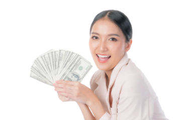 Excited Beautiful Asian Businesswoman in a light pink suit holding a fan of US dollar bills, expressing success and financial freedom, isolated on a transparent background for business money concepts