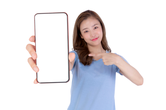 Young attractive Asian woman in a blue shirt smiling and pointing at a big smartphone with a blank white screen, isolated on a transparent background, promoting mobile app, digital online service