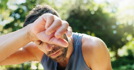 Outdoor, tired and man with workout, sweating and breathing with cardio, challenge and exhausted,...
