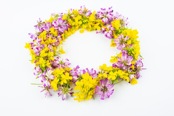Beautiful wreath made of rapeseed and astragalus flowers