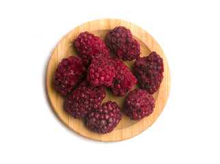 plate with dry blackberries on white background