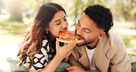 Couple, lunch and eating pizza outdoor at picnic together for romantic date or bonding for...