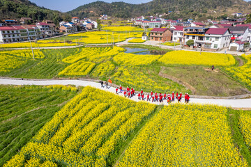 Senior tour group for spring outing at China's Hunan Rapeseed Flower Festival