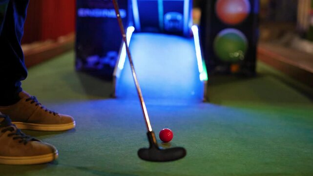 Mini Golf Putt Attempt Under Neon Lights