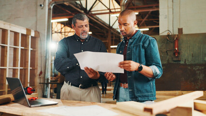 Blueprint, teamwork or men in woodworking workshop for factory, building craft or engineering...