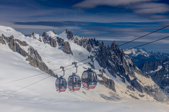 Cable car gondola in Chamonix Mont Blanc. Aiguille du Midi, Brevent and Valle Blanche Cable Car Telecabine Panoramic Mont-Blanc in French Alps mountain area. The top of the mountain glacier view point