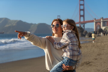 Mother and daughter have fun at the beach, focus on woman