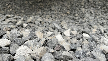Top view of granite stones outdoor. Crushed fraction granite background. Textured gray stone for...