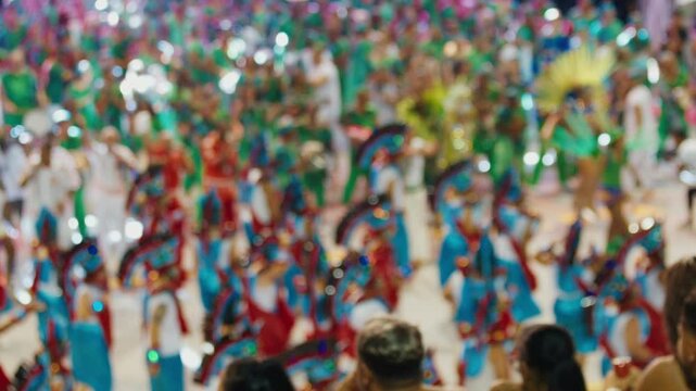 Brazilian carnival. Naturally blurred footage of the brazilian carnival and parade of school of samba performing on a sambodrome. People dance and celebrate on night parade of school of samba