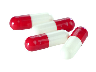 Bulk red and white capsule pills isolated on white background.