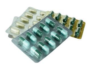 Bulk capsule pills blister packs isolated on white background.