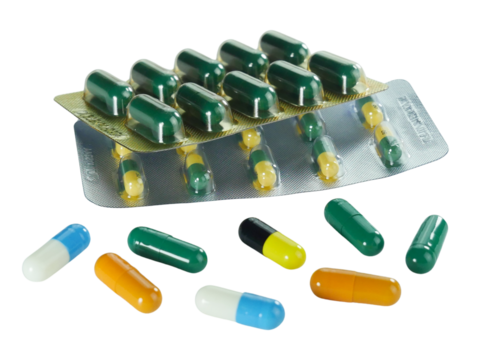 Bulk capsule pills blister packs isolated on white background.