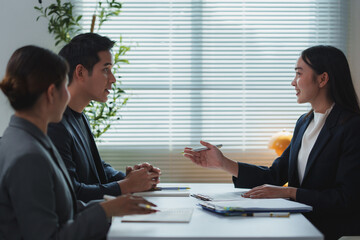 Businesspeople discussing contract terms during meeting in office