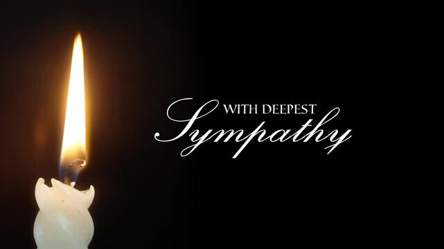 Text message With Deepest Sympathy appearing animated on black background a flickering candle casting warm light. Intimate solemn contemplative atmosphere.
