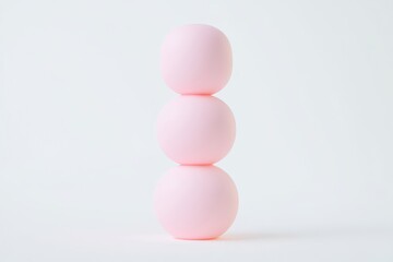 Fototapeta premium Three pastel pink spheres stacked vertically