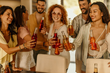 Happy friends toasting drinks at a party