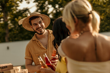 Friends enjoying drinks and pizza at a summer party