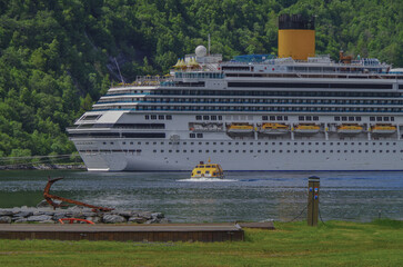 Modern mega cruiseship cruise ship liner Favolosa in Geirangerfjord with panoramic views of...