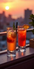 Two cocktails on a balcony at sunset