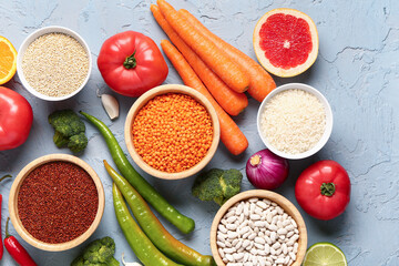 Different fresh vegetables and cereals on blue background