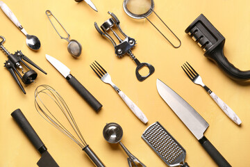 Different kitchen utensils on yellow background