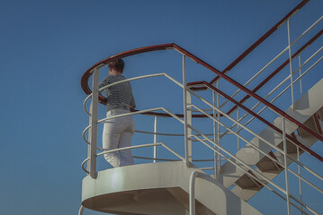 Woman day dreaming on luxurious transatlantic crossing aboard the luxury ocean liner cruise ship...