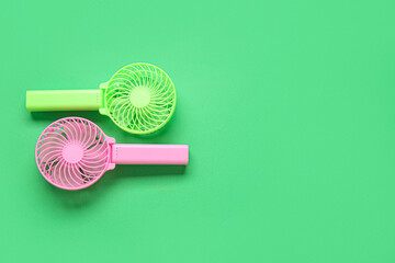 Different manual fans on green background