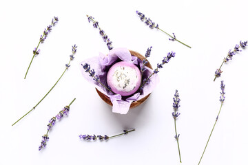 Composition with bath bomb and lavender flowers on white background