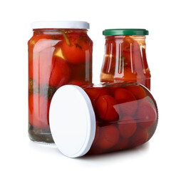Jars with canned tomatoes on white background