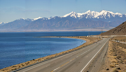 Route panoramique au bord d'un lac entouré de montagnes