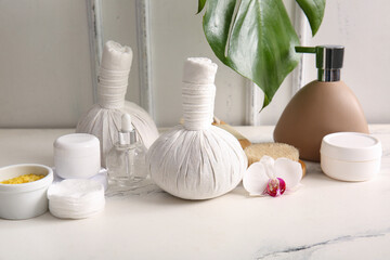 Set of cosmetic products and spa accessories on light table