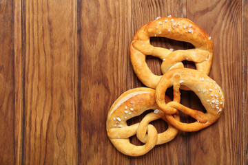 Soft pretzels on wooden background