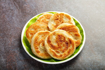 Soft and fluffy parathas , drenched in homemade ghee.
