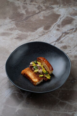 Delicately arranged gourmet food showcases rich flavors and textures, served in a contemporary European restaurant with an inviting ambiance. Perfect for food enthusiasts seeking culinary artistry