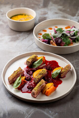 Indulge in a culinary journey at a European restaurant, where tender meat complements a colorful array of sauces and fresh vegetables, beautifully arranged and artfully crafted