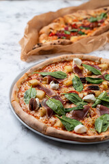 Elegantly presented gourmet pizza invites guests to savor a delightful combination of fresh herbs, savory meats, and rich cheeses. Enjoy a culinary experience perfect for sharing