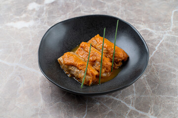 A beautifully plated dish awaits diners at a European restaurant, showcasing exquisite culinary craftsmanship. The vibrant colors and textures highlight the skillful presentation