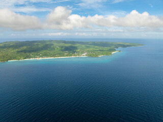 Tropical landscape of Island with beach surrounded by corals and blue sea. Carabao Island, Romblon....