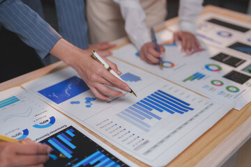 Business team analyzing financial charts and graphs, developing growth strategies during a collaborative working session, focusing on market trends and investment opportunities
