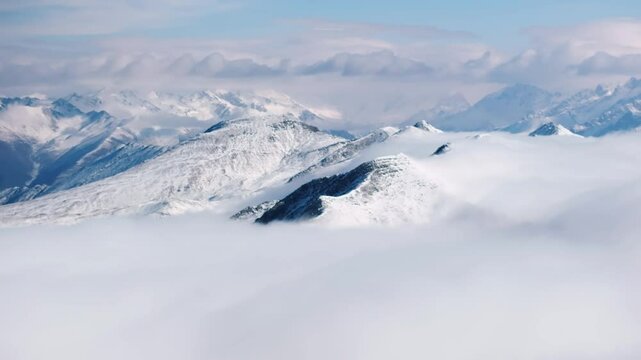 aerial view timelapse of winter snow mountain landscape with clouds mist moving