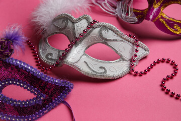 Carnival masks on pink background